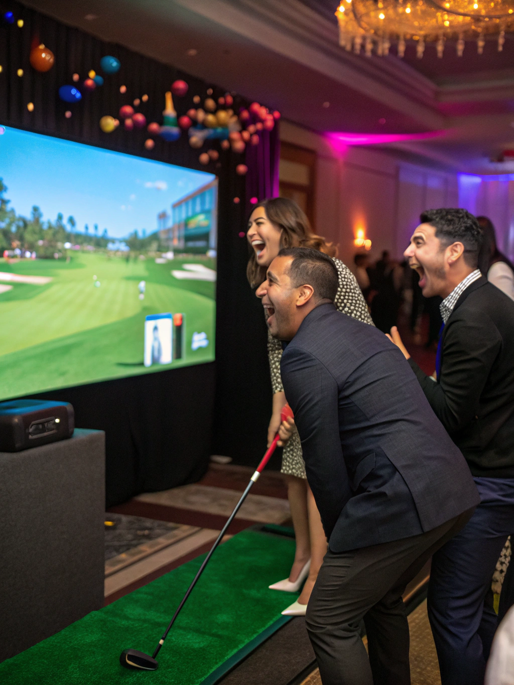 Guests enjoying an illuminated mobile golf simulation bay and inflatable enclosure at an evening event